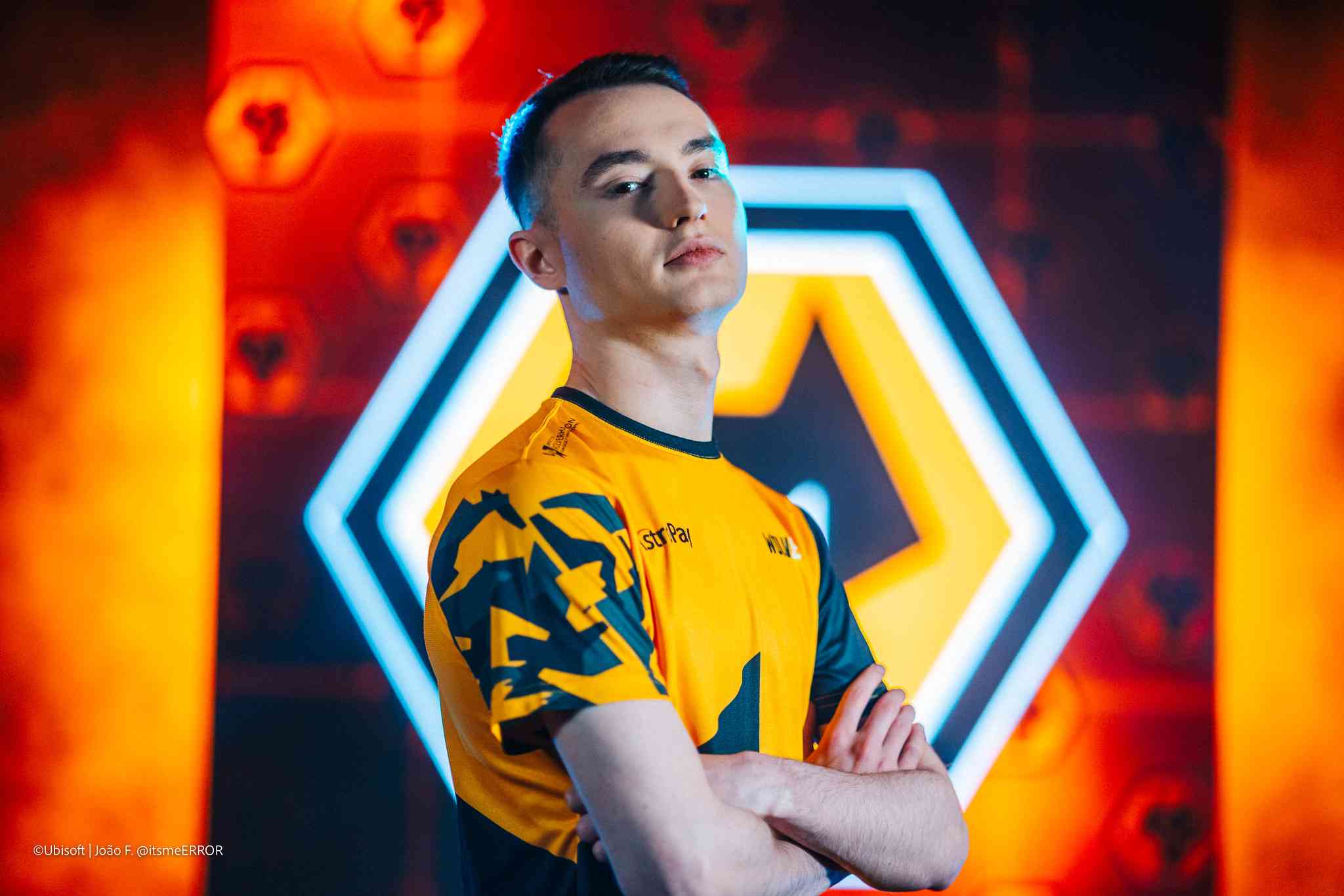 The player who's the one to watch player for Wolves, Axel 'Shiinka' Freisberg stands with arms folded in his team jersey.