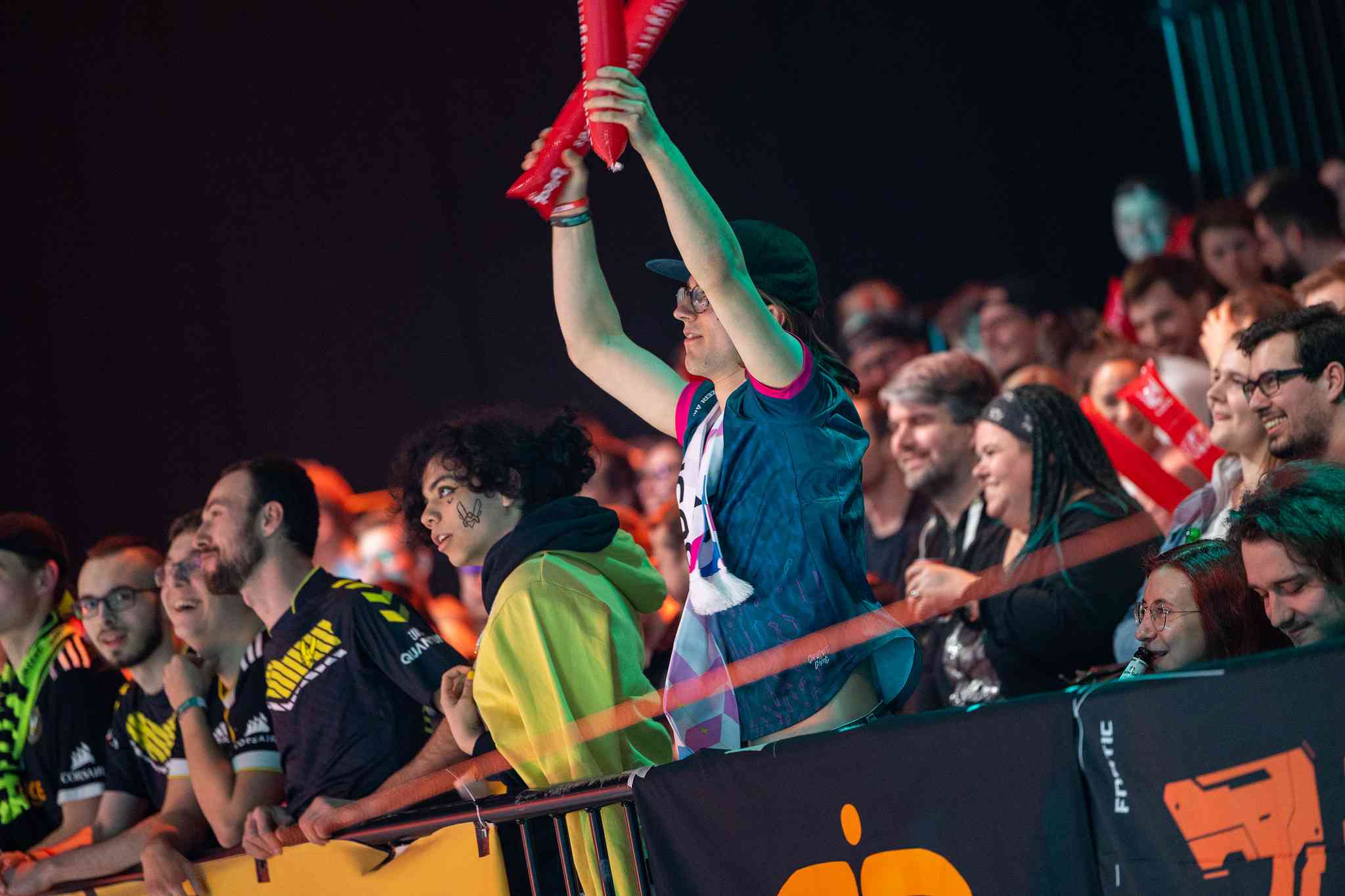 A lone BDS fan stands tall next to a group of VIT fans, cheering for the team