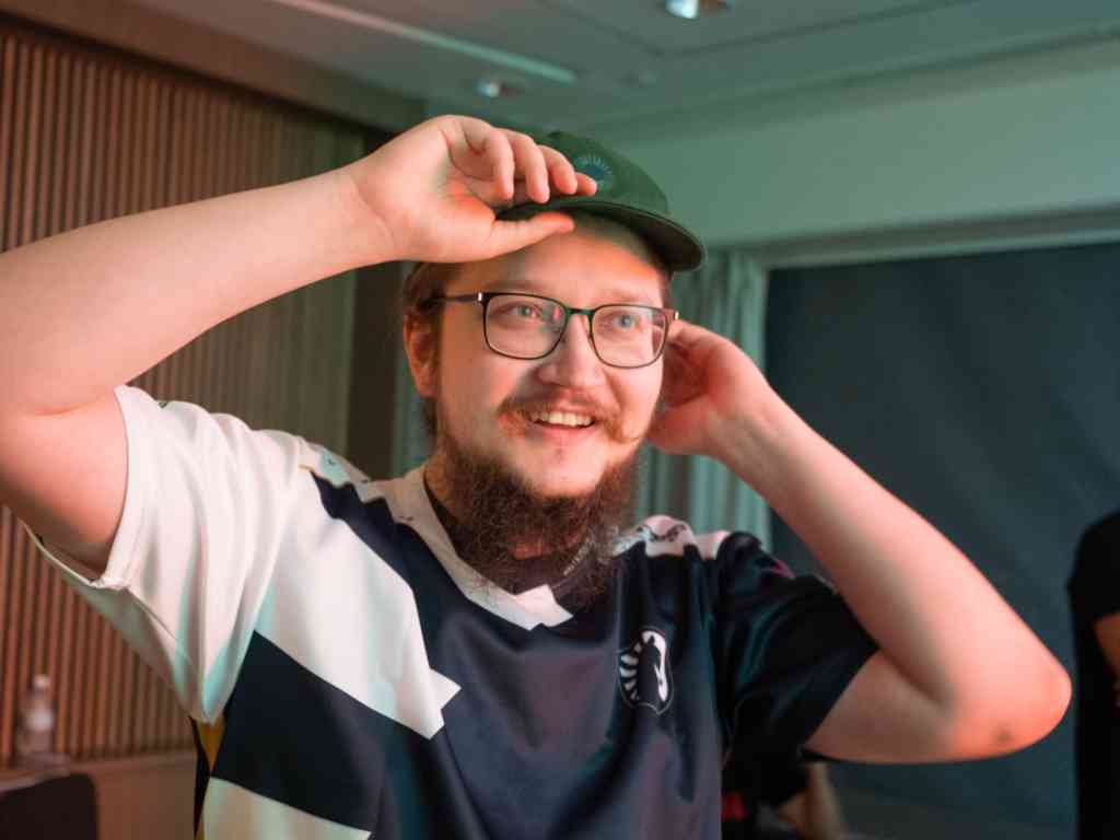 Matumbman, in his Team Liquid jersey, adjusts his baseball cap back stage at the Last Chance Qualifiers for TI 11.