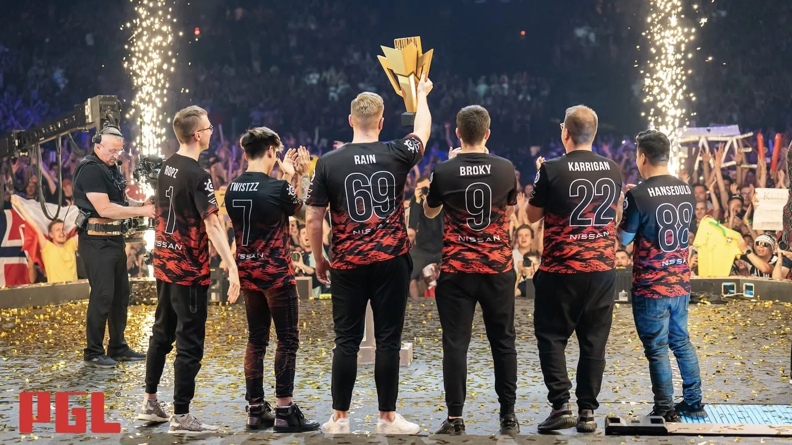 FaZe Clan stand together on stage holding the trophy after winning the Antwerp Major