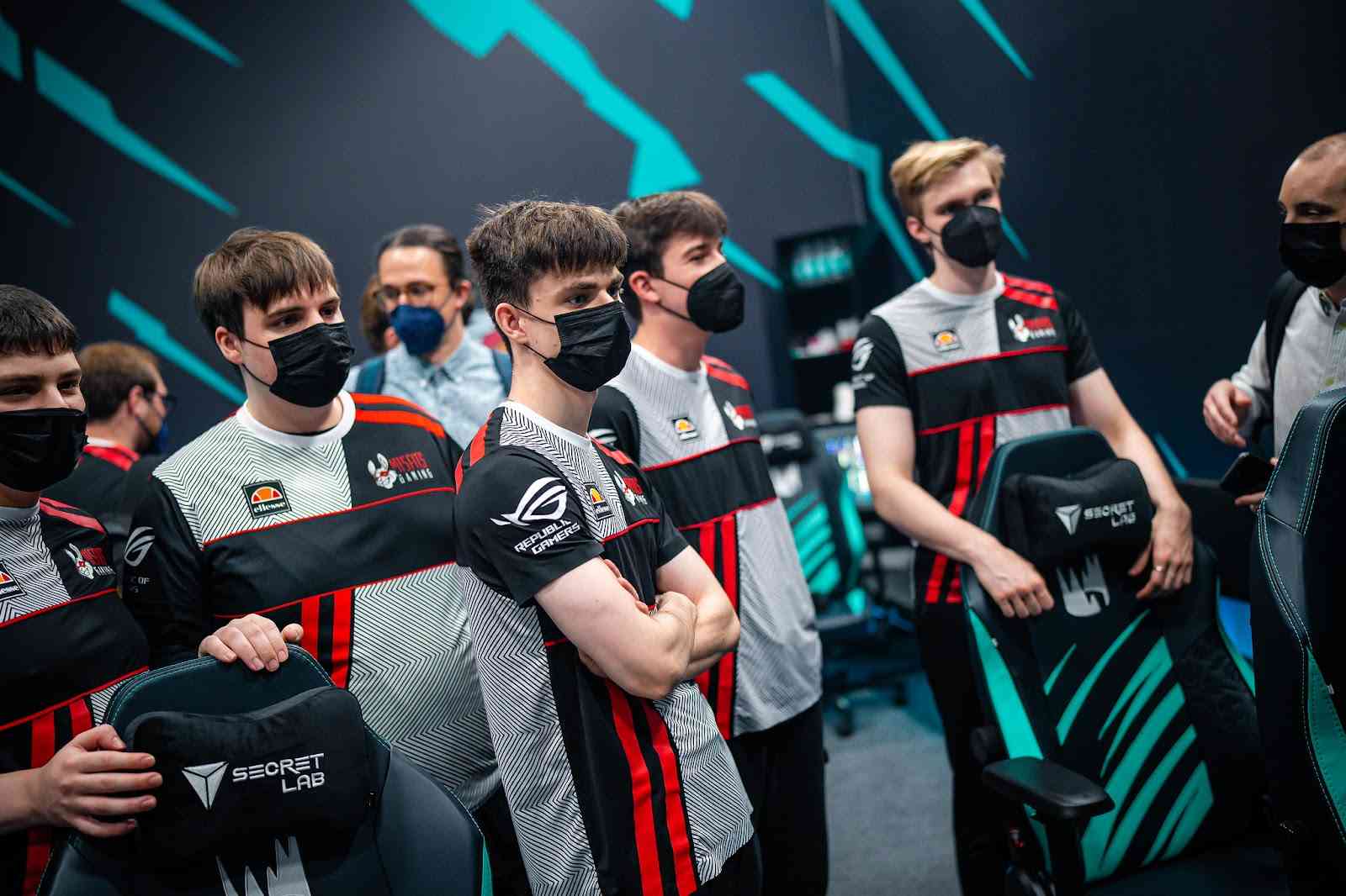 The roster for Misfits stand behind their gaming chairs ahead of the start of a game in the LEC Summer Split